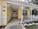 Inviting front porch detail with decorative trim, white railings, and ample space for seating at 1006 Tropical Dr, Bradenton, FL 34208