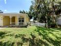 View of the landscaped front yard with white picket fence enhancing the curb appeal of the home at 1006 Tropical Dr, Bradenton, FL 34208