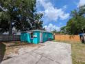 A spacious backyard with a concrete patio and a fenced perimeter for privacy and security at 1028 E 93Rd Ave # A, Tampa, FL 33612