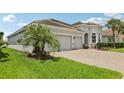 Stunning single-story home with a three-car garage, lush lawn and beautiful landscaping at 12004 Cinnamon Fern Dr, Riverview, FL 33579