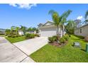 Alluring one-story home with lush landscaping, healthy green lawn, and a concrete driveway at 12739 Rainwashed Loop, Parrish, FL 34219