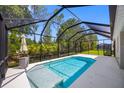 Inviting screened-in pool area with a clear blue pool, plenty of space to relax and enjoy the outdoors at 12739 Rainwashed Loop, Parrish, FL 34219