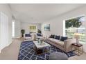 Cozy living room features neutral tones, stylish decor, and natural light from the large windows at 1280 Hill Flower Dr, Brooksville, FL 34604