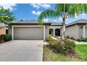 Charming single Gathering home with an attached two-car garage and verdant landscaping at 14047 Weddington Ter, Hudson, FL 34669