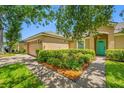 Attractive single-Gathering home with a well-maintained lawn and a splash of colorful flowers at 14819 Redcliff Dr, Tampa, FL 33625
