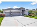 Stunning single-story home boasting a three-car garage and spacious driveway at 17651 Bright Wheat Dr, Lithia, FL 33547
