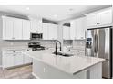 Bright kitchen featuring white cabinetry, stainless steel appliances, and a center island at 17651 Bright Wheat Dr, Lithia, FL 33547
