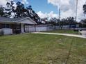 Well-kept lawn with single-story home and detached garage at 1922 Marvy Ave, Tampa, FL 33612