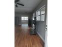 An open concept living room features vinyl flooring, a ceiling fan, and lots of natural light at 1922 Marvy Ave, Tampa, FL 33612