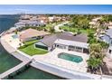 Beautiful waterfront home with a private dock, an inground pool, green lawn, and stunning bay views at 2002 Carolina Ne Cir, St Petersburg, FL 33703