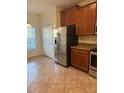 Bright kitchen with modern stainless steel refrigerator and ample cabinet space at 2411 Willimette Dr, Wesley Chapel, FL 33543