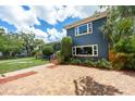 A view of the exterior of a well maintained home with brick driveway and beautiful landscaping at 2819 N Central Ave, Tampa, FL 33602