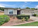 Charming single-story home with a well-maintained lawn, front garden, and two-car garage at 2823 Holly Bluff Ct, Plant City, FL 33566