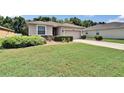 Well-maintained single-story home with a large lawn and mature landscaping at 2823 Holly Bluff Ct, Plant City, FL 33566