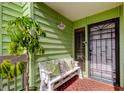Inviting entryway with a charming bench, potted plant, and security door at 318 Windrush Blvd # 10, Indian Rocks Beach, FL 33785