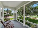 Inviting front porch with comfortable seating and a view of the beautifully landscaped yard at 3220 W San Pedro St, Tampa, FL 33629