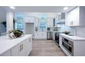 Bright kitchen featuring white cabinets, stainless steel appliances, and stunning marble countertops at 35 Deerpath Dr, Oldsmar, FL 34677