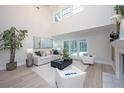 Bright living room with high ceilings, fireplace, and sliding doors that lead to a pool at 35 Deerpath Dr, Oldsmar, FL 34677