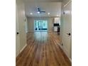 Bright living room featuring hardwood floors, neutral paint, recessed lighting, and access to the kitchen at 4639 Cabbage Palm Dr, Valrico, FL 33596