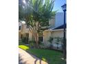 Exterior view of the townhouse with a manicured lawn and lush landscaping at 5100 Burchette Rd # 1304, Tampa, FL 33647