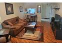Cozy living room with hardwood floors, a comfortable brown sofa, and a dining area at 5100 Burchette Rd # 1304, Tampa, FL 33647