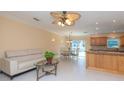 Inviting living room with tile floors, modern furniture, and view to the kitchen and dining area at 516 7Th Se St, Largo, FL 33771
