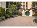 Well maintained building entry with covered entrance and attractive landscaping at 5430 Eagles Point Cir # 202, Sarasota, FL 34231