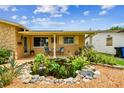 Welcoming front porch with pond and seating, enhancing curb appeal at 5726 20Th N Ave, St Petersburg, FL 33710