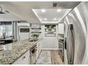 Bright kitchen with granite countertops, stainless steel appliances, and a window over the sink at 5744 Thrush Dr, New Port Richey, FL 34652