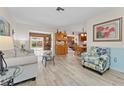 Open-concept living room featuring wood-look floors, neutral paint, and views to the back patio at 6289 107Th N Ave, Pinellas Park, FL 33782
