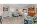 Bright living room boasting wood-look floors, neutral paint, and a view to the pool at 6289 107Th N Ave, Pinellas Park, FL 33782