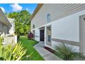 Home exterior with a view of the entryway, lush landscaping, and well-kept lawn in a peaceful setting at 6439 Gentle Ben Cir, Wesley Chapel, FL 33544
