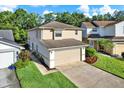 Well-maintained home exterior with a two-car garage, green lawn, and attractive landscaping enhancing curb appeal at 6439 Gentle Ben Cir, Wesley Chapel, FL 33544