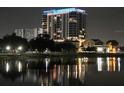 Night view of a modern high-rise building reflected in the still waters of a lake at 777 3Rd N Ave # 1304, St Petersburg, FL 33701