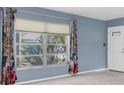 Bright living room featuring a large window that offers natural light and views of the outdoors at 8451 Candlewood Rd # 8451, Seminole, FL 33777