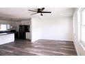 A naturally lit living room features luxury vinyl plank flooring, a ceiling fan, and an open design at 8807 Mary Ivy Dr, Plant City, FL 33567