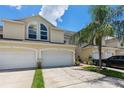 Charming townhome featuring a 1-car garage, lush landscaping, and a welcoming entrance at 1050 Starkey Rd # 704, Largo, FL 33771