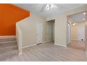 Inviting hallway with light wood floors, neutral walls, and stairway leading to another level at 1050 Starkey Rd # 704, Largo, FL 33771