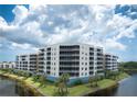 Waterfront condo building featuring balconies and picturesque views, highlighting its desirable location at 10520 Boardwalk Loop # 202, Bradenton, FL 34202