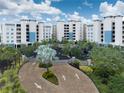 Grand entrance to waterfront condos with lush landscaping and brick-paved drive, setting a welcoming tone at 10520 Boardwalk Loop # 202, Bradenton, FL 34202