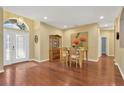 Inviting foyer featuring hardwood floors, natural light, and an elegant dining area, perfect for welcoming guests at 11153 Biddeford Pl, New Port Richey, FL 34654