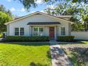 Charming single-story home featuring a well-maintained lawn and inviting curb appeal at 11799 Raintree Dr, Temple Terrace, FL 33617