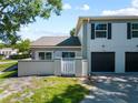 Exterior view of the home showcasing its rear entrance and attached garage at 11799 Raintree Dr, Temple Terrace, FL 33617