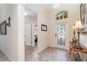 Inviting foyer with decorative tile flooring, high ceilings, and an arched window above the ornate front door at 13194 Royal Pines Ave, Riverview, FL 33579