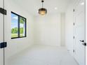 Bright and airy office space featuring white tile floors, modern lighting, and a large window at 14080 Sydney Rd, Dover, FL 33527