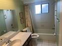 Bathroom featuring a shower/tub combo, a window, and a vanity with a sink at 1813 Laurel Oak Dr, Valrico, FL 33596
