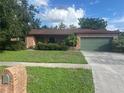 Charming single-story brick home featuring a well-maintained lawn and a brick mailbox at 1813 Laurel Oak Dr, Valrico, FL 33596
