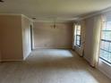 Spacious living room with neutral carpet, a chandelier, and large windows allowing for natural light at 1813 Laurel Oak Dr, Valrico, FL 33596