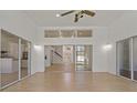 Open living room featuring wood floors and large sliding doors at 19206 Ivy Oak Way, Tampa, FL 33647