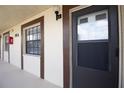 Close-up of a condo entrance showcasing the well-maintained exterior and modern design at 2400 Winding Creek Blvd # Bldg18A210, Clearwater, FL 33761